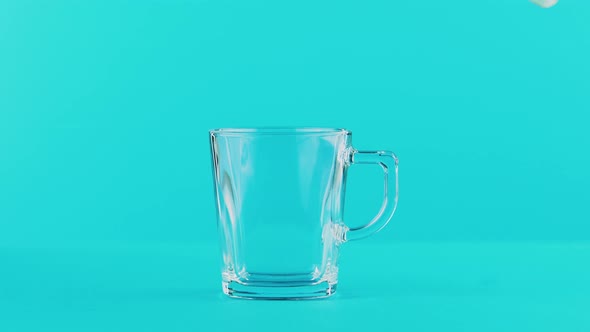 Milk Cold Beverage Drink Pooring Into Glass Mug with Handle Blue 