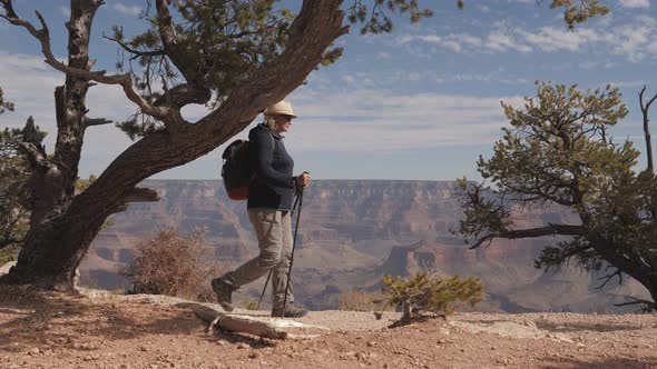 Elderly Woman With A Backpack Hiking In The Mountains Of The Grand Canyon Park