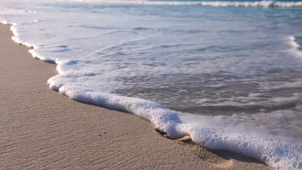 Sunset on Beach with Waves on the Ocean