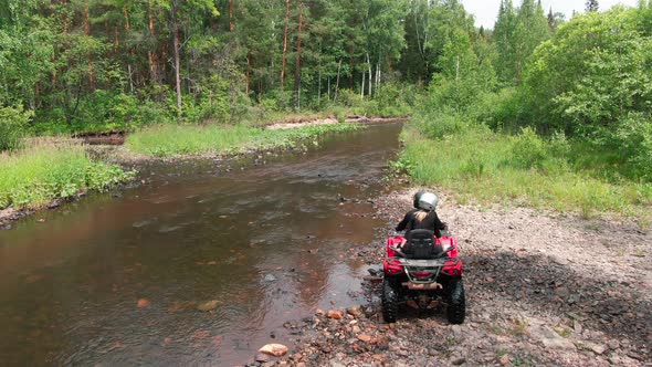 Aerial View of Couple Driving Quad Bike through River