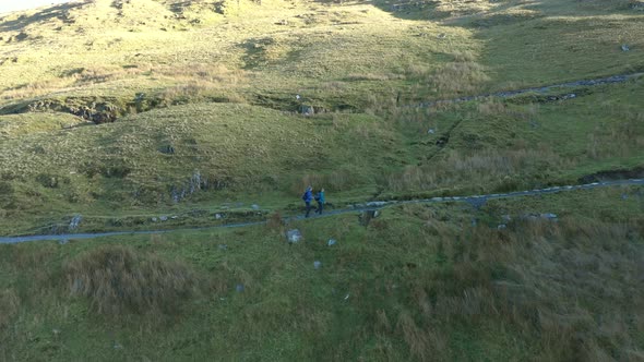 Aerial view of people hiking and climbing Snowdon mount in Wales on a sunny d