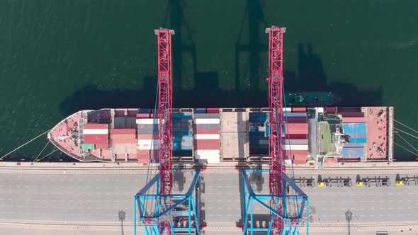 Drone Flying Over a Container Ship During Cargo Operations Over the Customs Area