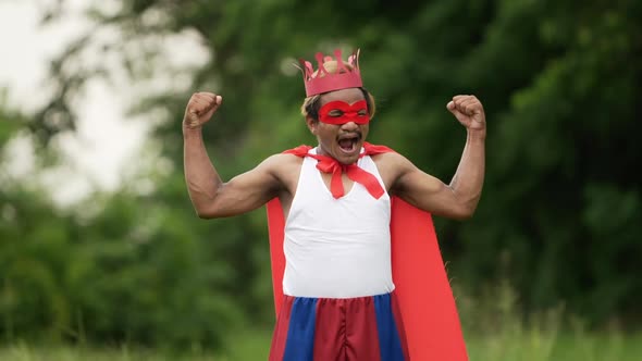 Hero man in red with crown and red mask roaring and standing