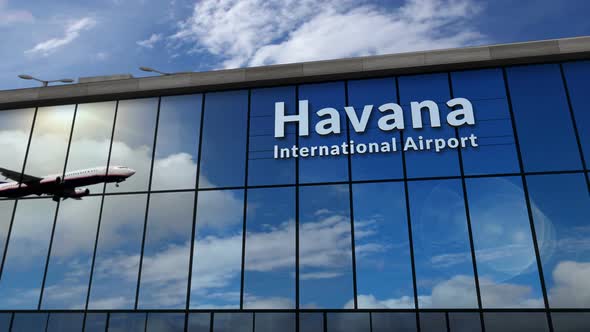 Airplane landing at Havana Cuba airport mirrored in terminal