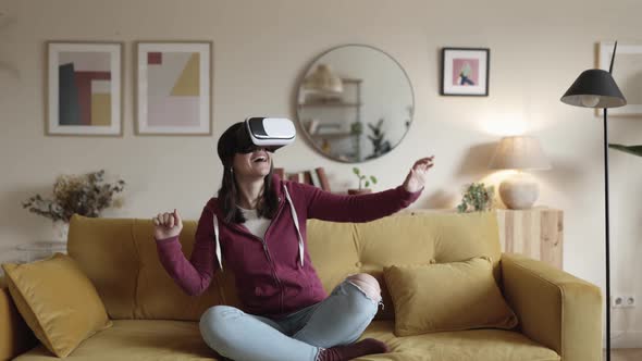 Woman Having Fun While Using Virtual Reality Glasses at Modern Apartment