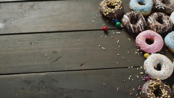 Video of donuts with icing on wooden background