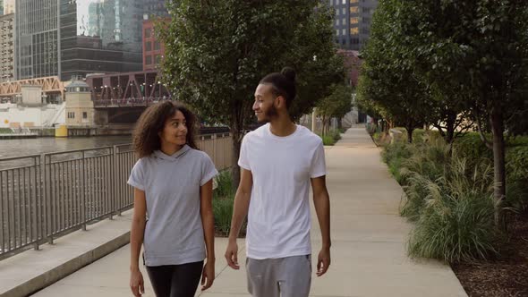 Cute African American couple walk together along the Chicago River