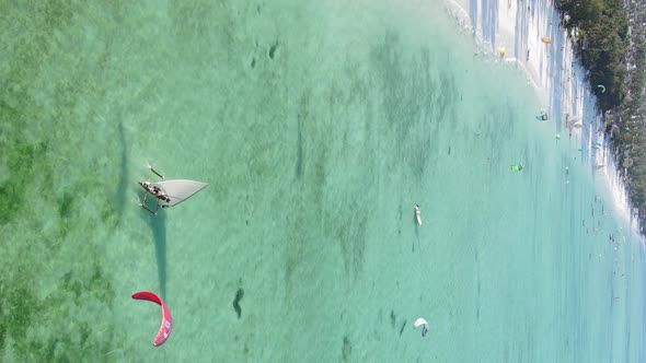 Vertical Video Kitesurfing Near the Shore of Zanzibar Tanzania Aerial View