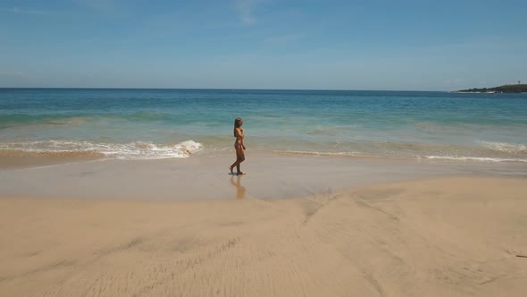 Girl Walking on the Beach