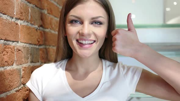 Thumbs Up By Young Woman Positive Gesture at Home