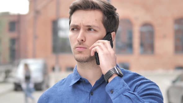Outdoor Portrait of Young Man Talking on Phone