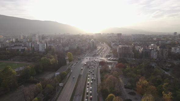 Aerial Urban View of City Traffic on Main Street in Sofia at Sunset Over Vitosha Mountain