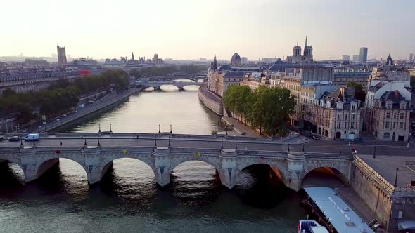 Flying Drone view on Pont Neufing away. Gradually revealing Ile de la Cite with Conciergerie and Not