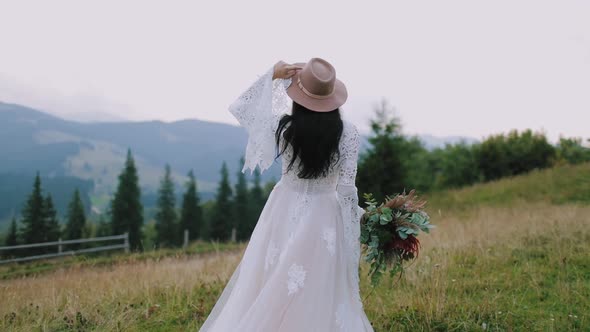 Rear view of a bride in the mountains
