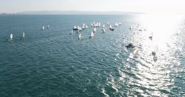 Aerial view of sailing boats navigating near Acre Old City port in Israel.