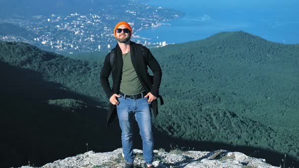 Hipster Backpacker Showing Welcoming Gesture Coming with Him Waving Hands and Making Cool Thumb Up