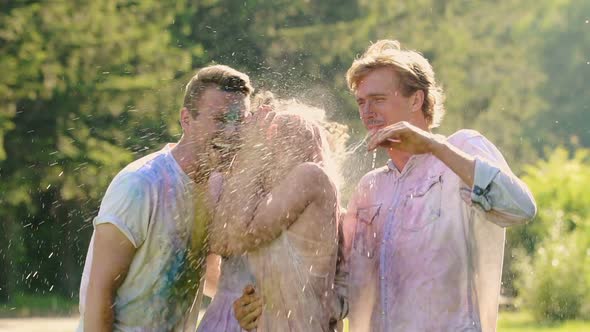 Two Loving Couples Getting Splashed With Water After Colorful Powder Paint Fight