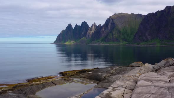 Beautiful Norwegian rocky coast and mountain ridge