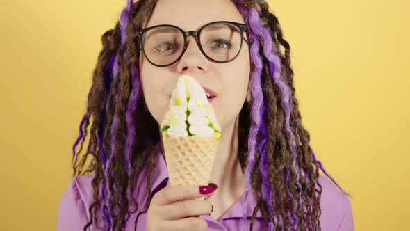 Young Woman in Glasses Licking Ice Cream Smiling Looking at Camera