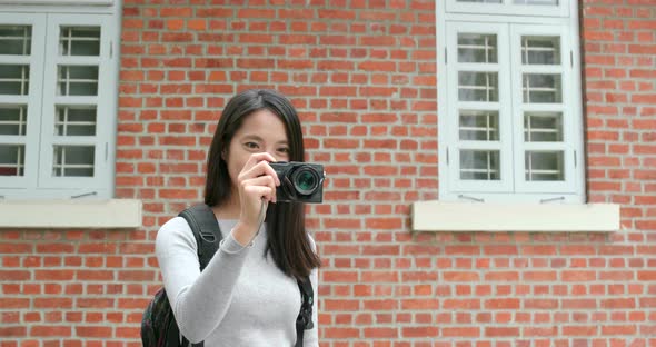 Woman travel and holding digital camera for taking photo