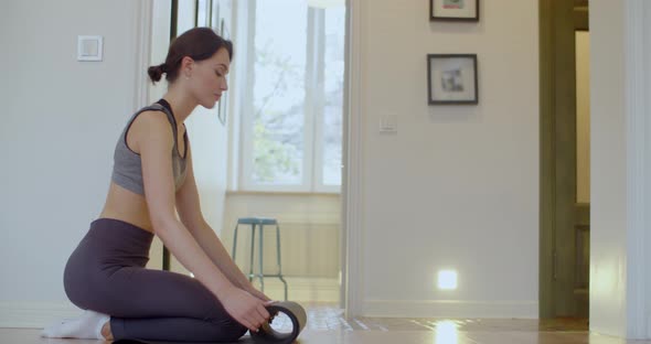 Slim Woman Unrolling Mat Before Yoga Practice Indoors Natural Light Slow Motion