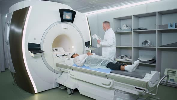 Magnetic Resonance Imaging in the Modern Hospital Adult Man Doctor Performs a Magnetic Tomographic