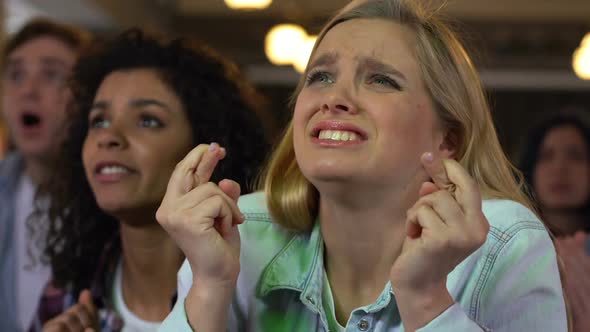 Fans Emotionally Cheering for Sports Team Victory Watching Football Match in Bar