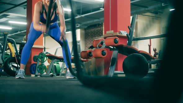 Professional Athlete Workouts with Ropes in Gym. alt