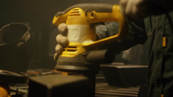 Worker polishing metal