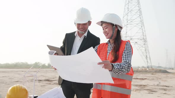 engineers look at the construction of high-voltage power. Teams engineer looking discussing plan