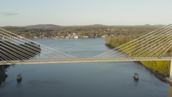 Flying over the Penobscot Narrows Bridge during autumn golden hour AERIAL