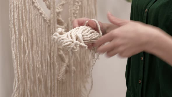 Woman Weaves Macrame on a Stick