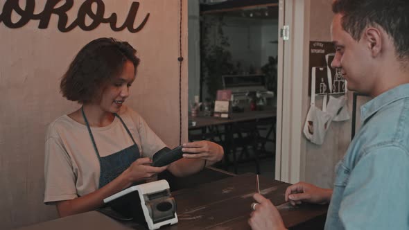 Man Paying for Ceramics with Card