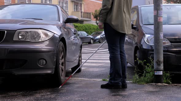 woman with a disability has to get around a car parked on the sidewalk