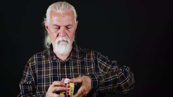 Man Plays With A Colorful Cube