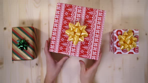 High angle of hands arranging a gift box