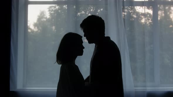 Lovely Woman Hugging Man on Window Background Wife and Husband Reconciling After Conflict Standing