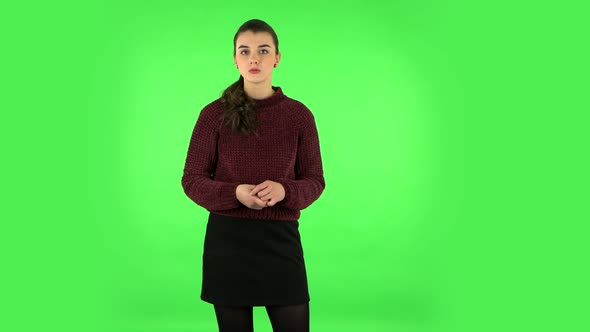 Girl Listens To Information Looking at Camera, Is Shocked and Very Upset. Green Screen