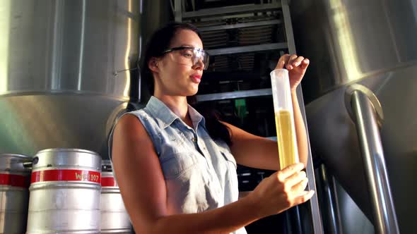 Female brewer testing beer 4k