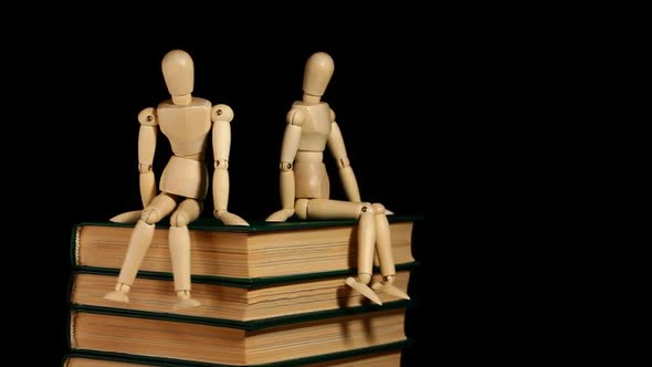 footage of wooden figure book dark background