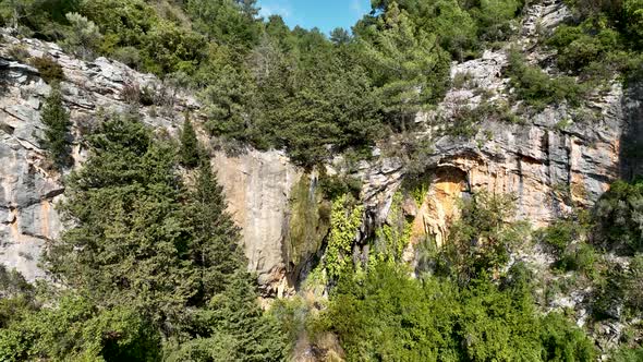 A small waterfall in the mountains aerial view 4 K