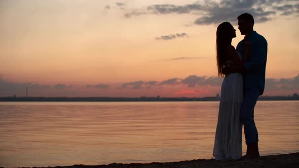 Silhouette of Loving Couple on Romantic Date at Lake