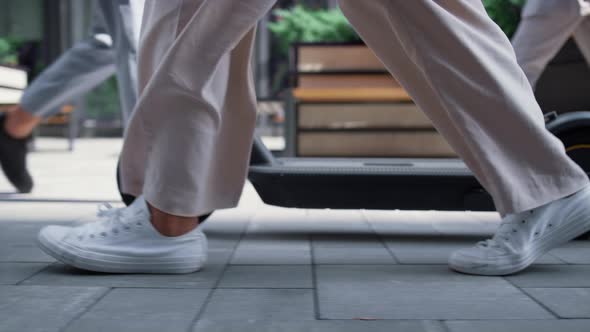 Closeup Female Legs Walking with Electric Scooter at Downtown Street in Morning