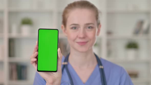 Young Female Doctor Holding Smartphone with Chroma Key Screen 