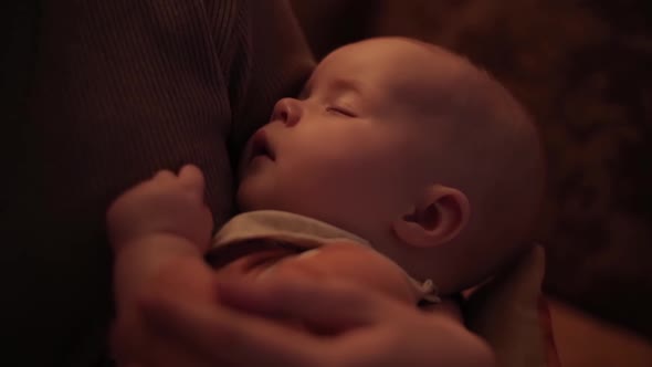 Mother Holding Arms of Newborn Baby. Care and Safety. Cozy.