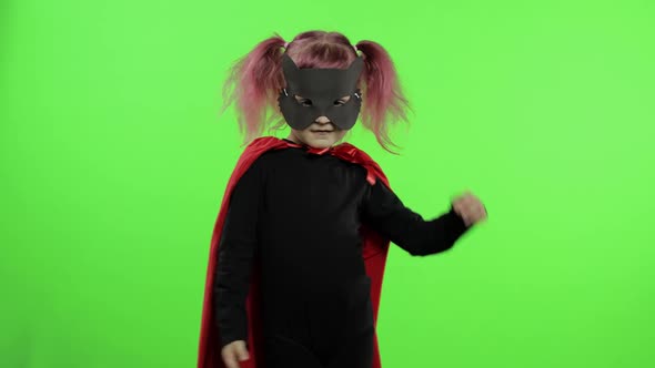 Funny Child Girl in Costume and Mask Plays Super Hero. National Superhero Day