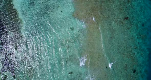 Daytime aerial abstract view of a summer white paradise sand beach and blue water background 