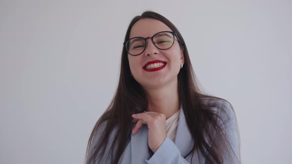 Portrait of a Young Laughing Business Lady in Glasses on a White Isolated Background