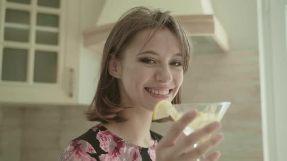 Beautiful Young Brunette Woman At Home In The Kitchen