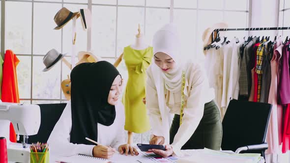 Muslim women fashion designers are in process of creating new clothes collection.